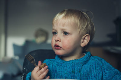 Portrait of cute boy eating at home