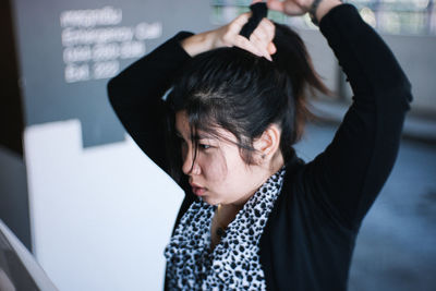 Portrait of a woman sitting on camera