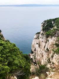 High angle view of rocks by sea against sky