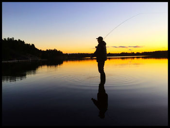 Scenic view of lake at sunset