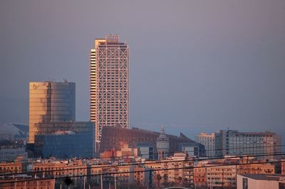 Modern buildings in city against clear sky