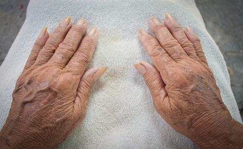 High angle view of couple hands