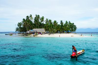 Man and woman in boat at beach