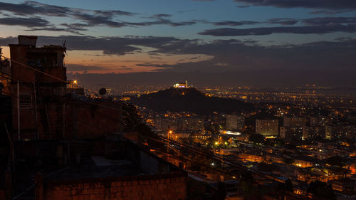 High angle view of illuminated city buildings at sunset