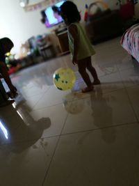 Low section of people walking on tiled floor