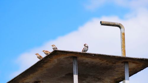 Low angle view of built structures against clear blue sky