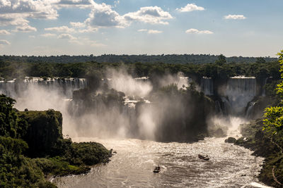 Scenic view of waterfall against sky