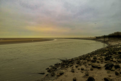 Scenic view of beach against sky during sunset