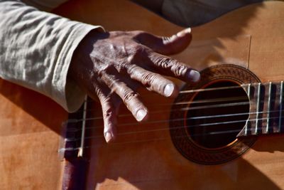 Cropped image of person playing guitar