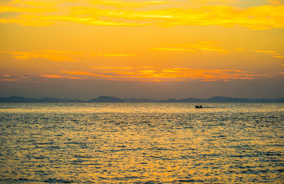 Scenic view of sea against orange sky