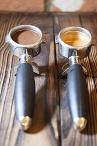 Photo of coffee, pre and post grinded on wooden table