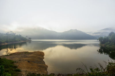 Scenic view of lake and mountains against sky