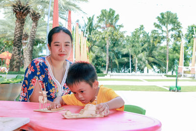 Portrait of mother and girl looking at table