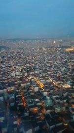 High angle view of illuminated buildings in city against clear sky