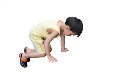 Side view of boy against white background