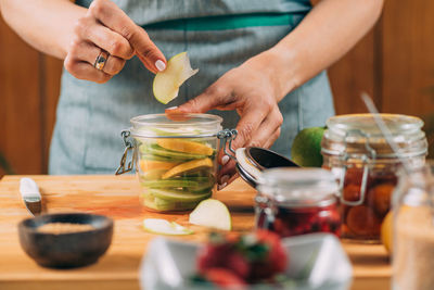 Midsection of man preparing food on table