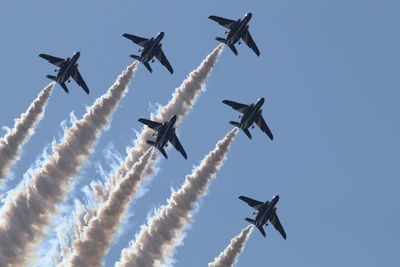 Low angle view of airplane flying against sky