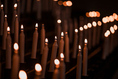 Close-up of illuminated candles in temple