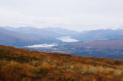 Scenic view of lake against cloudy sky