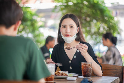 Portrait of a woman with drink in restaurant