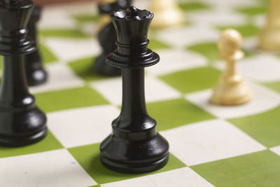 Close-up of chess pieces on floor