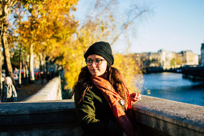 Portrait of beautiful young woman in park during autumn