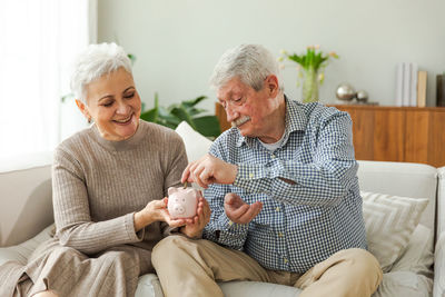 Senior couple sitting on sofa at home