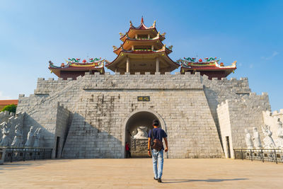 Full length of man walking against temple