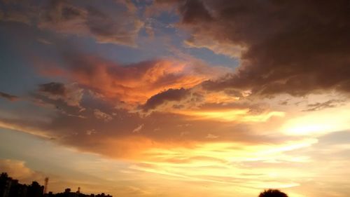 Low angle view of cloudy sky at sunset