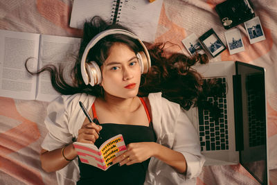 Portrait of a beautiful young woman standing at home