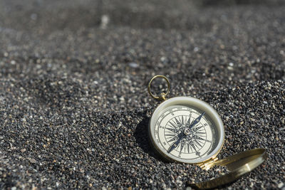 Close-up of compass at beach