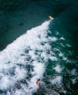 High angle view of people in sea. surfing 