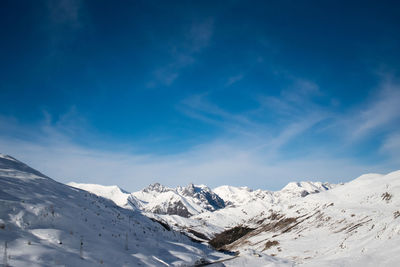 Low angle view of snow mountains against sky