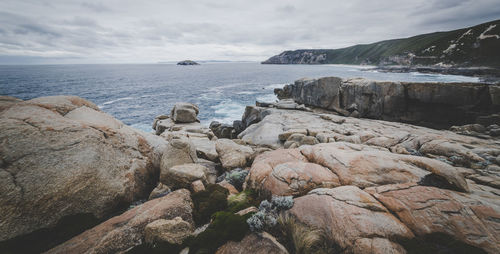 Rocks on beach against sky