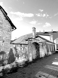 Graffiti on wall of old building against sky