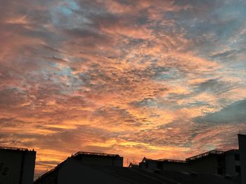 Low angle view of silhouette city against sky during sunset