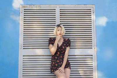 Woman standing against wall