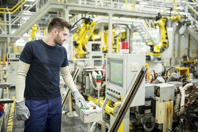 Man working in a modern factory operating a machine