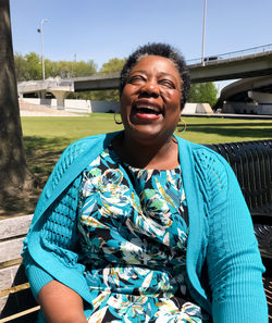 Close-up of smiling woman sitting outdoors