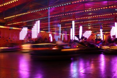 Illuminated ferris wheel in city at night