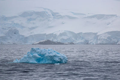 Scenic view of frozen sea against mountain