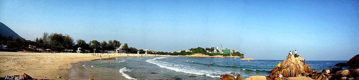 Panoramic view of beach against clear blue sky