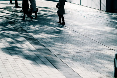 Low section of woman walking on zebra crossing