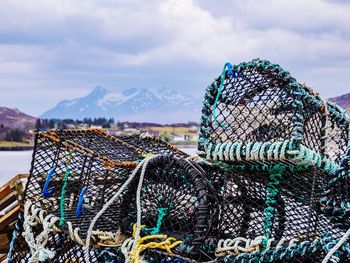 Fishing net on beach against sky