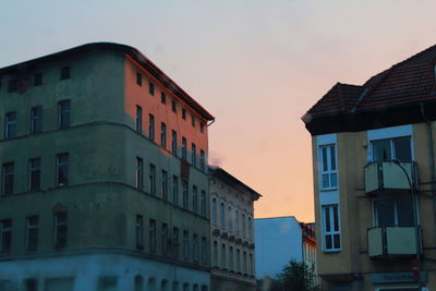 Low angle view of buildings against sky during sunset