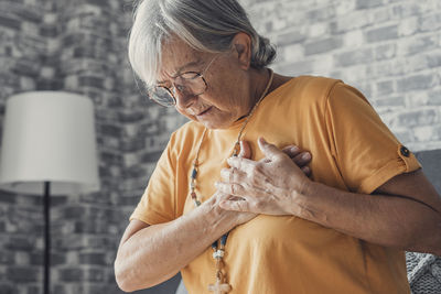 Side view of senior man holding hands