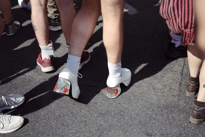Low section of people walking on road