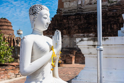 Statue against historic building