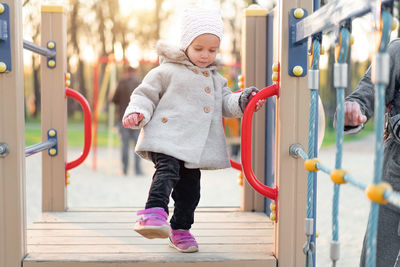 Cute girl at playground during winter
