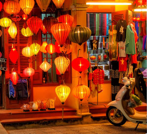 Illuminated lanterns hanging for sale at night